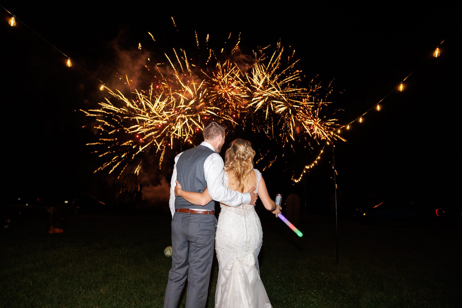 A couple surrounded by sparklers after dark