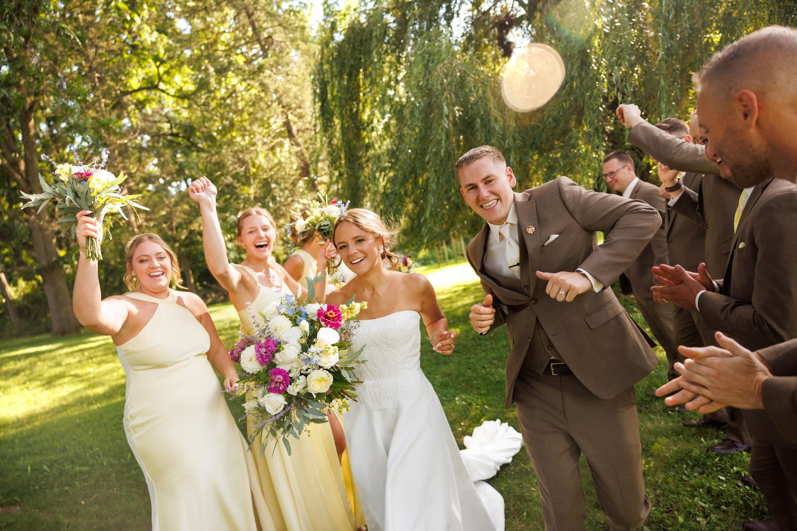 The wedding party cheering the couple through